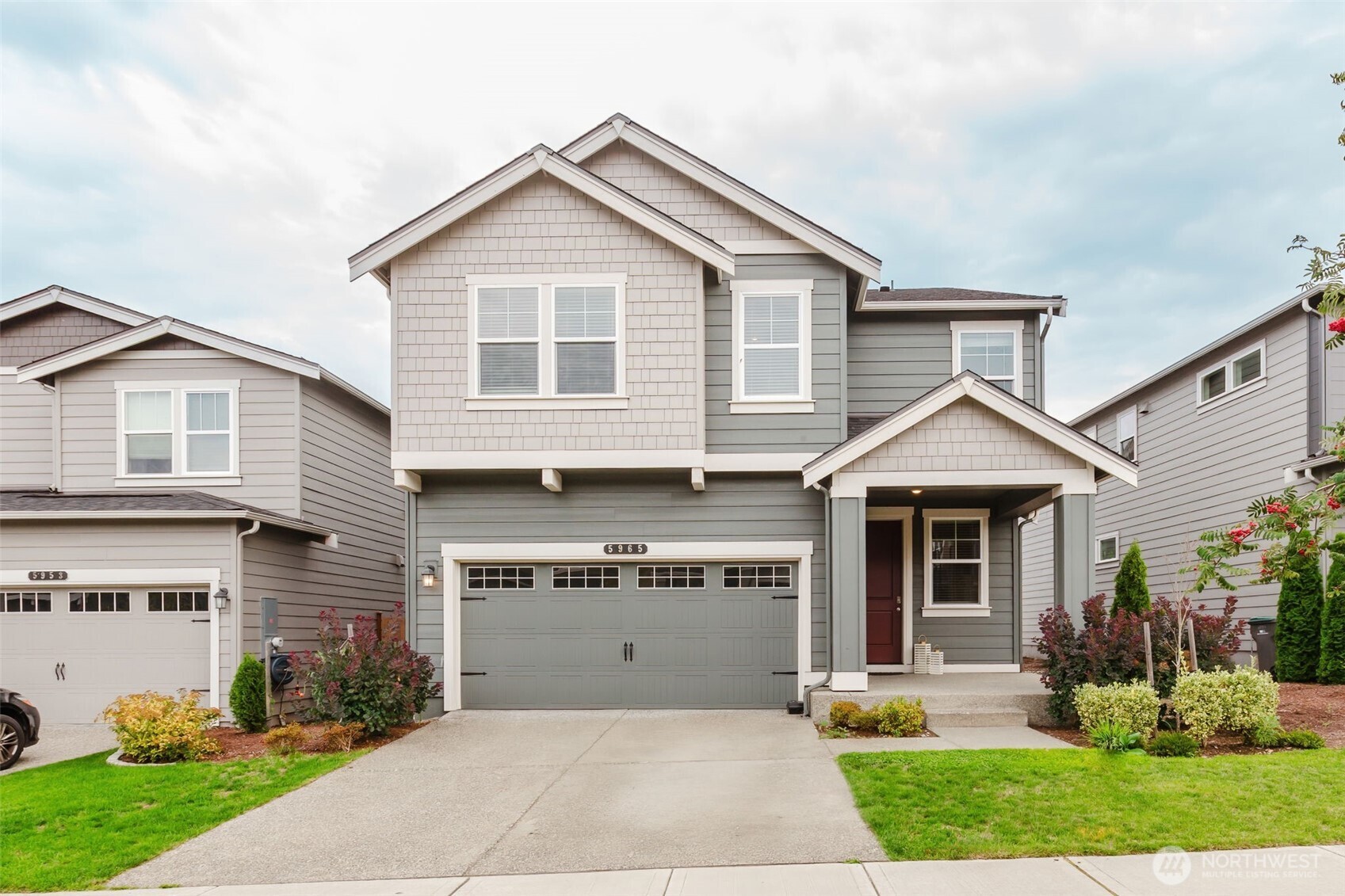 a front view of a house with a garden and plants