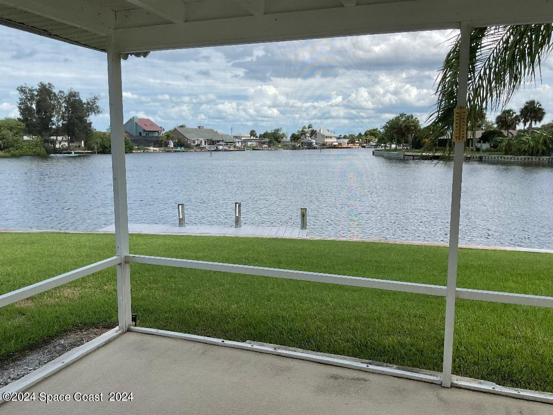 1725 Reef Court Merritt Island, FL 32952 - Photo 2 of 5 a view of a lake with houses in the background