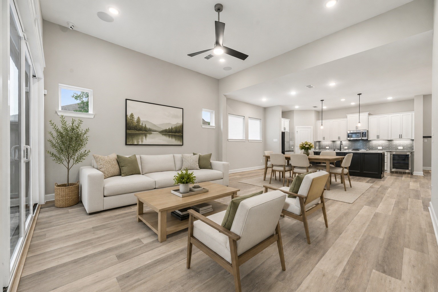 3438 Rich Radish Road Richmond, TX 77406 - Photo 3 of 25 The open-concept family room features high ceilings and seamless flow into the gourmet kitchen and dining spaces, completely unified by gorgeous upgraded flooring and a bright, modern color scheme. Virtually staged.