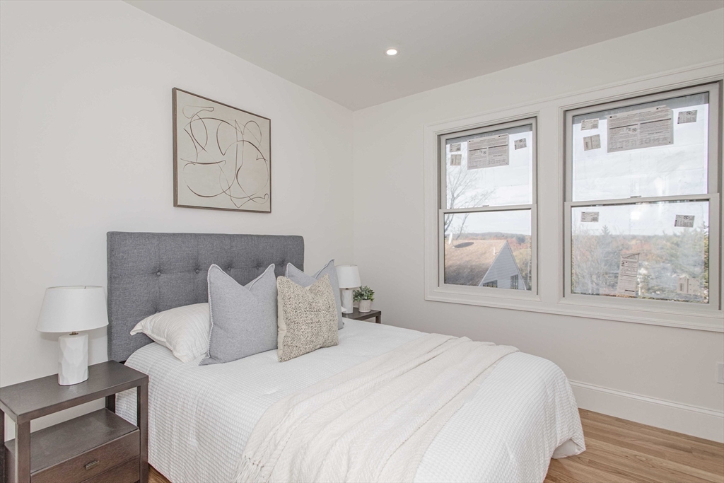125 Mt Vernon Street, Unit 2 Newton, MA 02465 - Photo 23 of 36 a bedroom with a bed and a window