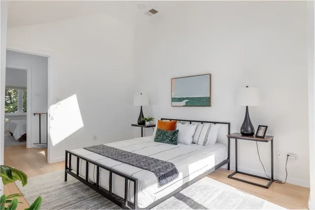 a bedroom with a bed and a night stand