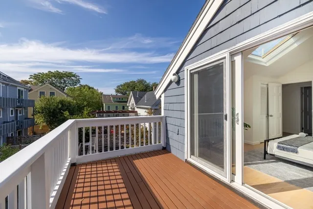 a view of a balcony with wooden floor and fence