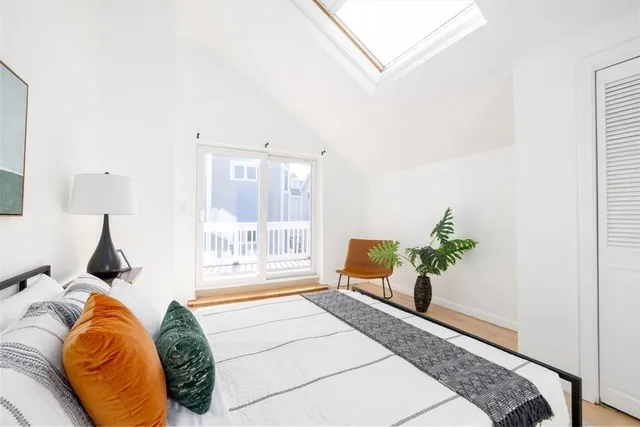 a bed sitting in a bedroom next to a window