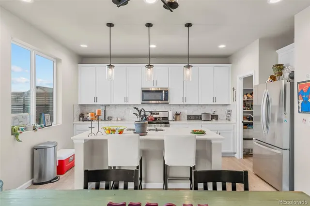 a kitchen with stainless steel appliances granite countertop a refrigerator sink and cabinets