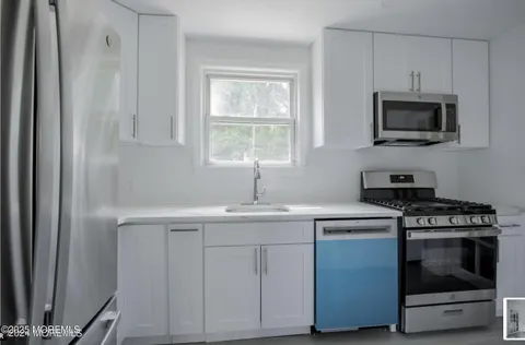 a kitchen with stainless steel appliances granite countertop a stove and a refrigerator