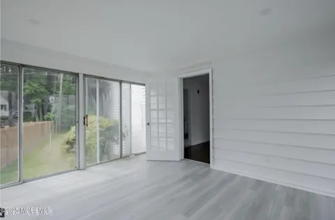 a view of an empty room with a floor to ceiling window and a floor to ceiling window