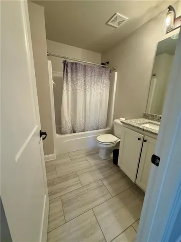 a bathroom with a sink a toilet a mirror and shower