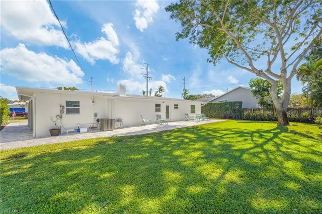 a view of a house with a backyard and a small yard