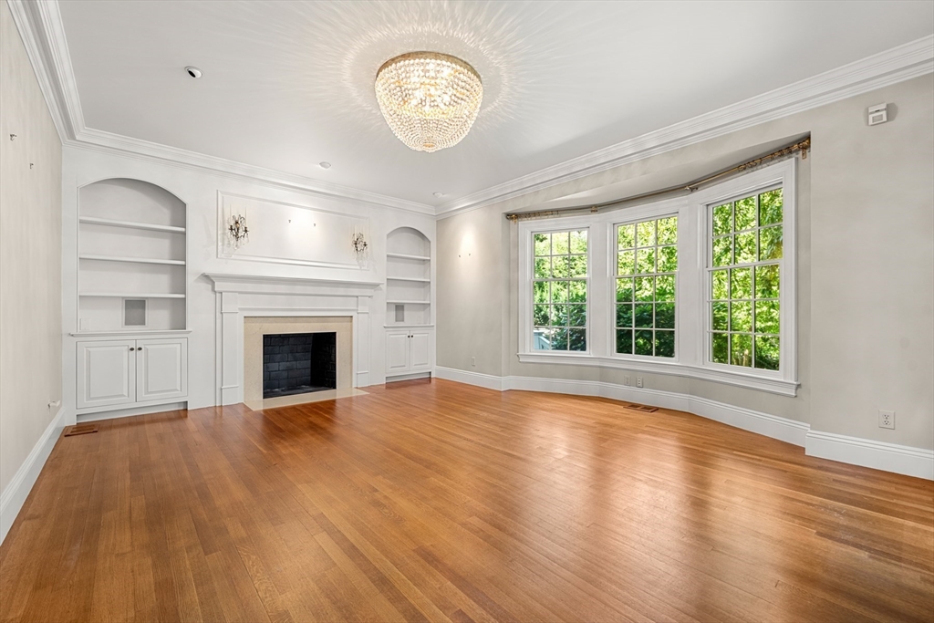 3 Ravine Road Wellesley, MA 02481 - Photo 14 of 33 a view of an empty room with wooden floor and a window