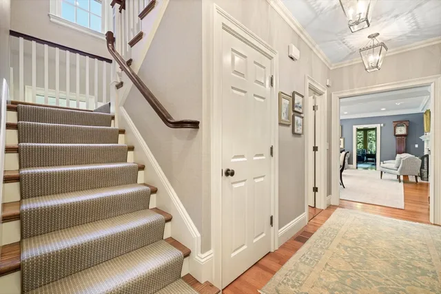 a view of entryway and hall with wooden floor