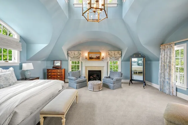 a bedroom with a bed and a fireplace