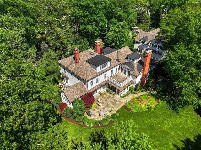 an aerial view of a house with a yard