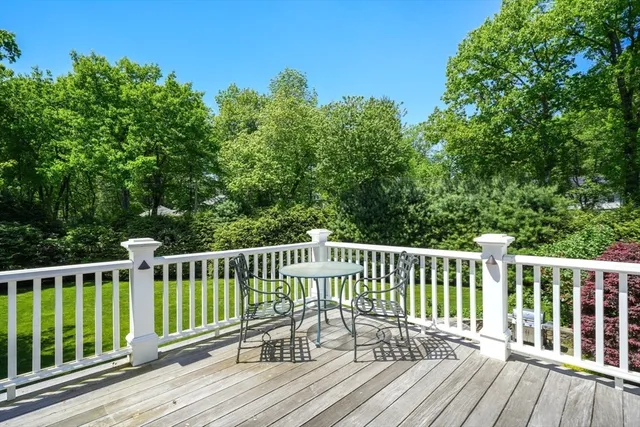 a view of balcony with wooden floor and fence