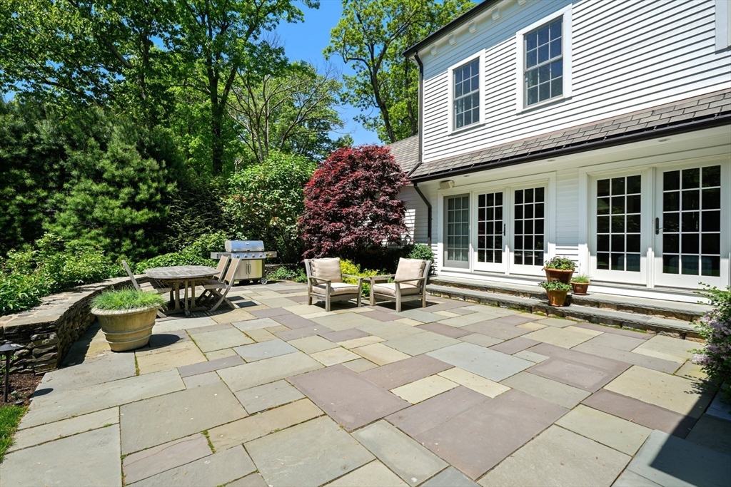 3 Ravine Road Wellesley, MA 02481 - Photo 26 of 33 a view of a patio with table and chairs and potted plants