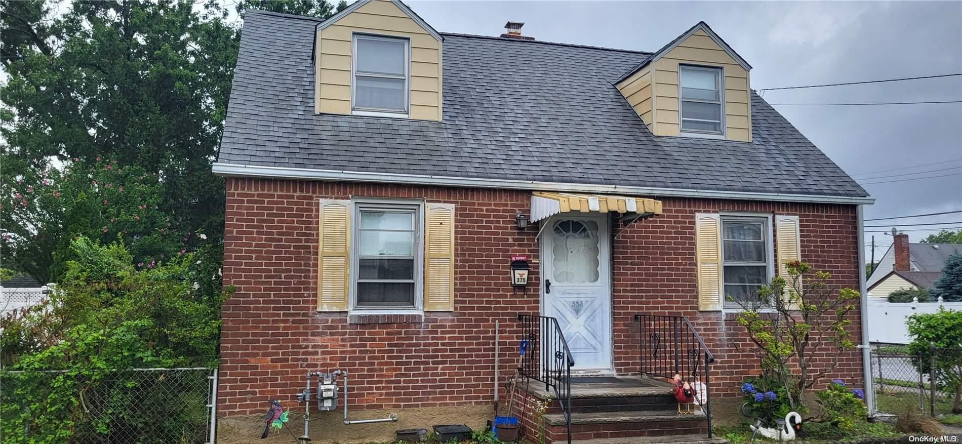 375 Beebe Road Mineola, NY 11501 - Photo 1 of 1 a view of a house with brick walls and potted plants