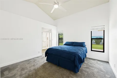 a living room with a bed and a window