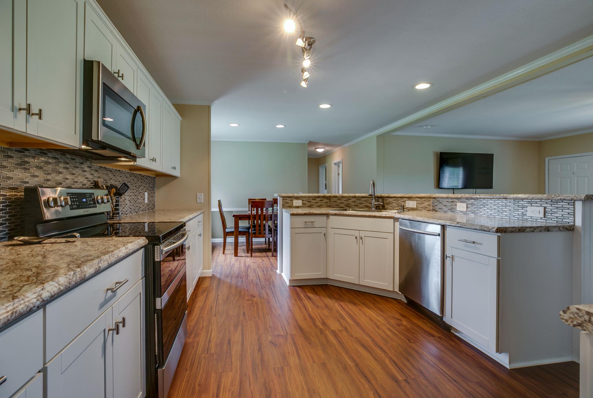 513 Ferrells Loop Road Manchester, TN 37355 - Photo 8 of 29 a kitchen with stainless steel appliances granite countertop wooden cabinets granite counter tops and a hard wood floors
