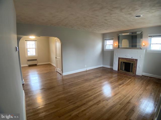 205 Twin Oaks Road Linthicum, MD 21090 - Photo 4 of 16 a view of empty room with wooden floor and fireplace