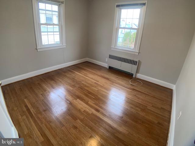 205 Twin Oaks Road Linthicum, MD 21090 - Photo 8 of 16 an empty room with wooden floor and windows