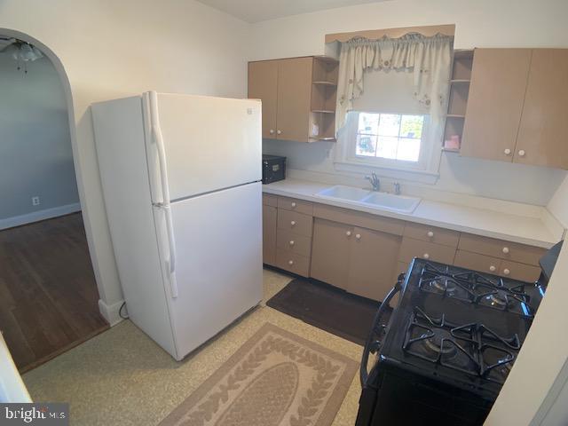 205 Twin Oaks Road Linthicum, MD 21090 - Photo 9 of 16 a white refrigerator freezer sitting inside of a kitchen