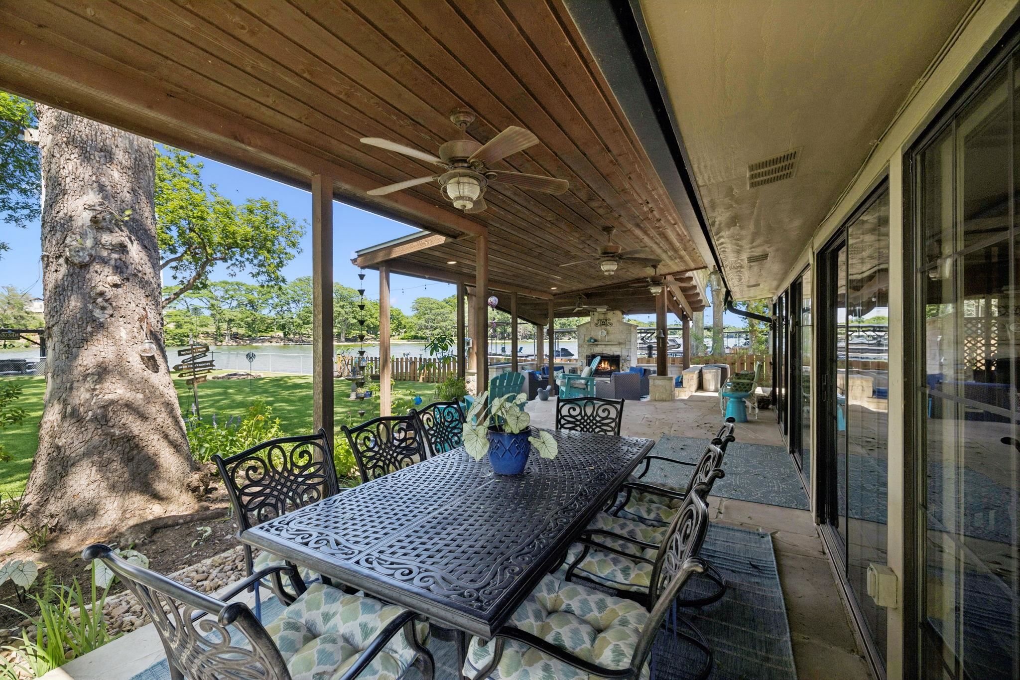 1435 East Zipp Road New Braunfels, TX 78130 - Photo 9 of 43 a view of a patio with table and chairs potted plants and floor to ceiling window