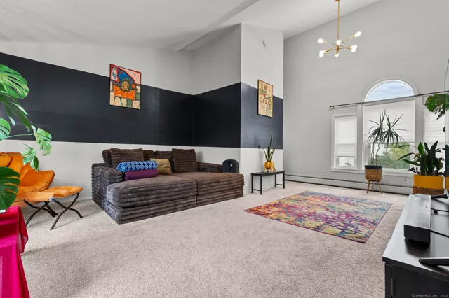 a living room with furniture and a chandelier