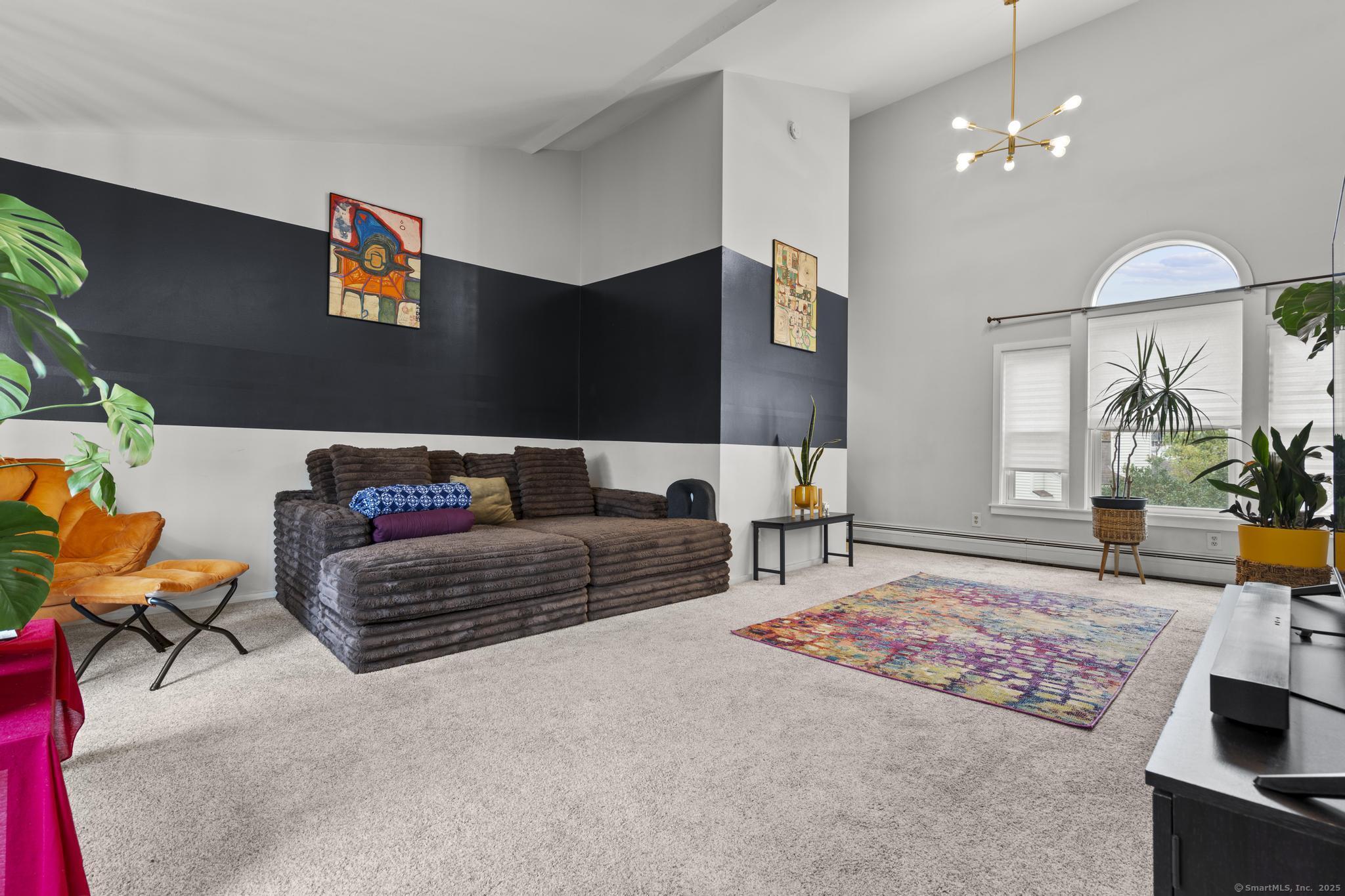 a living room with furniture and a chandelier