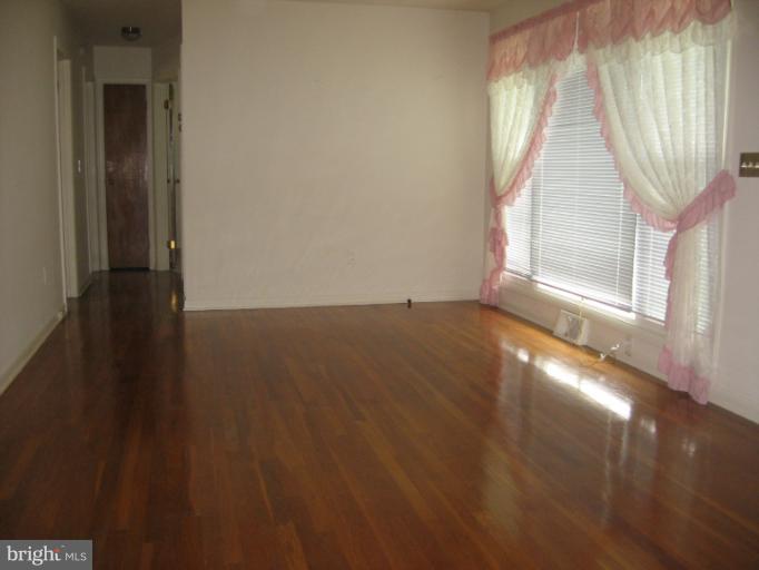 800 Boom Road Berryville, VA 22611 - Photo 1 of 13 an empty room with wooden floor and windows