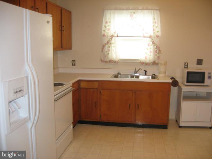 800 Boom Road Berryville, VA 22611 - Photo 2 of 13 a room with a refrigerator a sink and a window