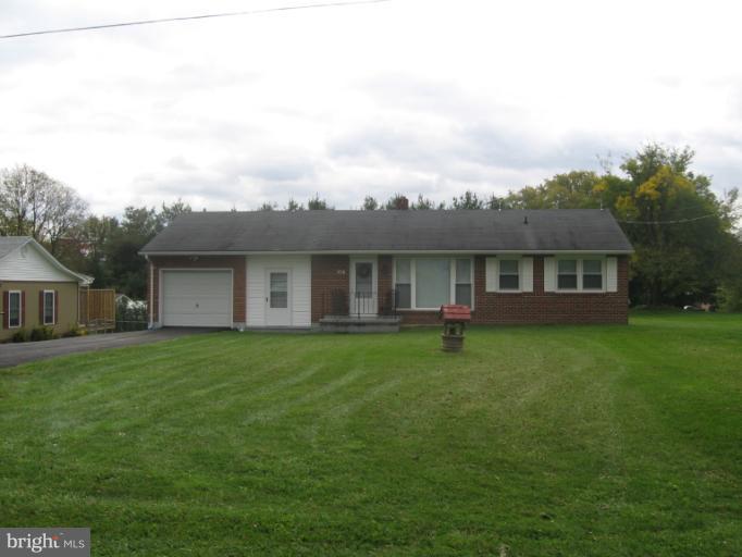 800 Boom Road Berryville, VA 22611 - Photo 13 of 13 a backyard of a house with table and chairs