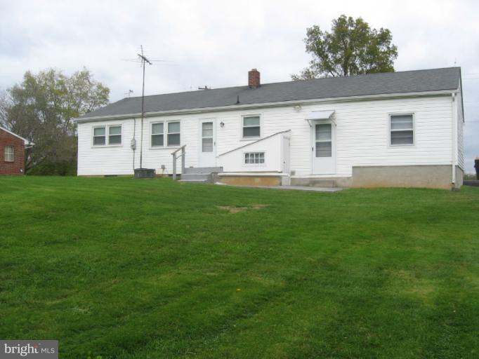 800 Boom Road Berryville, VA 22611 - Photo 3 of 13 a front view of a house with a garden
