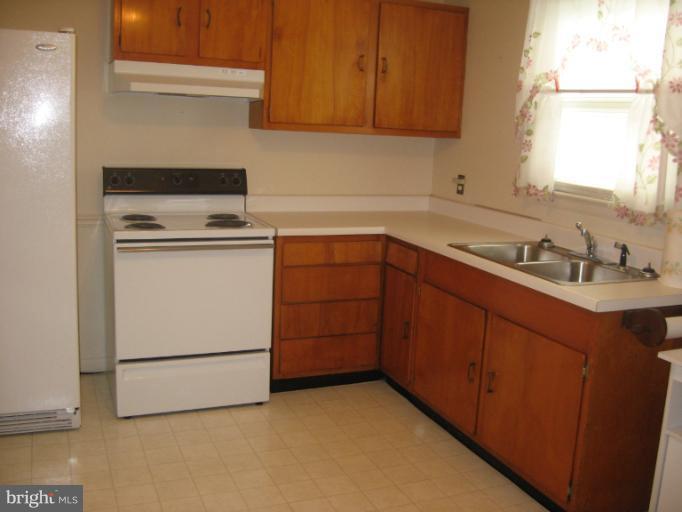 800 Boom Road Berryville, VA 22611 - Photo 6 of 13 a kitchen with sink a stove and cabinets
