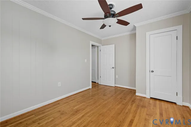 a view of an empty room with wooden floor