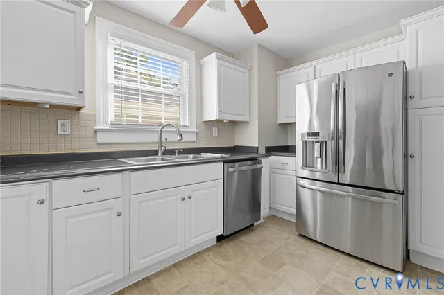 a kitchen with appliances a window and a refrigerator