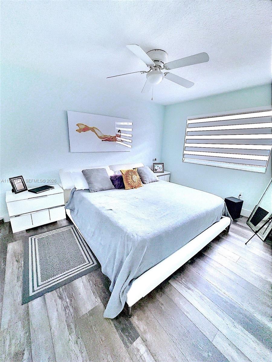 6761 Northwest 182nd Street, Unit 103 Hialeah, FL 33015 - Photo 11 of 13 a bedroom with a bed and window