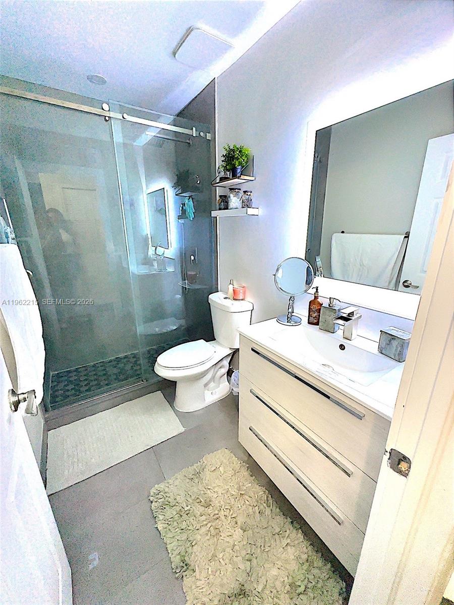 6761 Northwest 182nd Street, Unit 103 Hialeah, FL 33015 - Photo 12 of 13 a bathroom with a sink toilet and shower