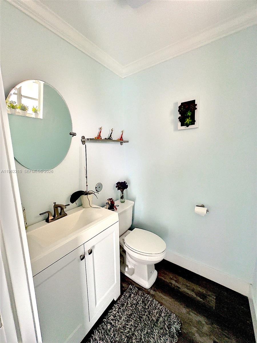 6761 Northwest 182nd Street, Unit 103 Hialeah, FL 33015 - Photo 3 of 13 a bathroom with a sink toilet and mirror