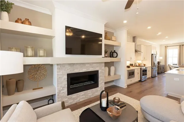 a living room with furniture a fireplace and flat screen tv