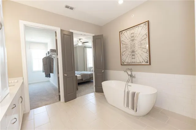 a bathroom with a tub and a view of bathroom
