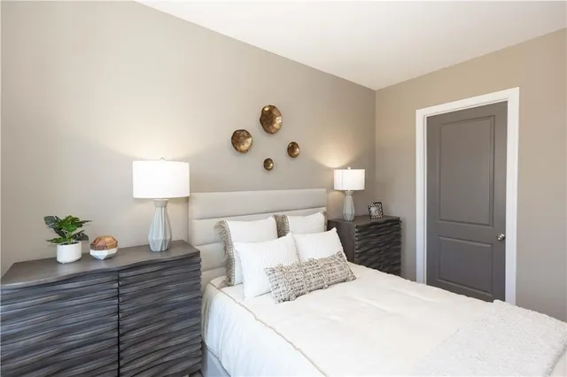 a bedroom with a bed and a lamp on table