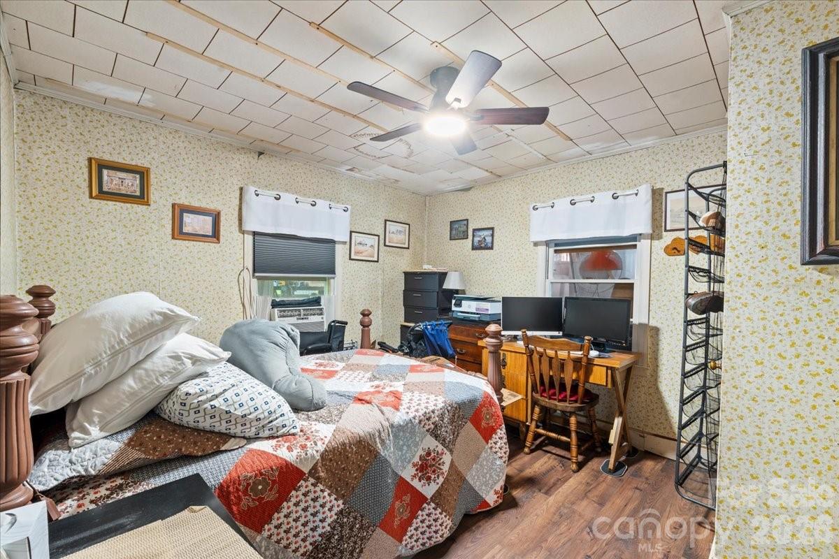 12282 Coyle Road Stanfield, NC 28163 - Photo 12 of 24 a bedroom with furniture and a fireplace