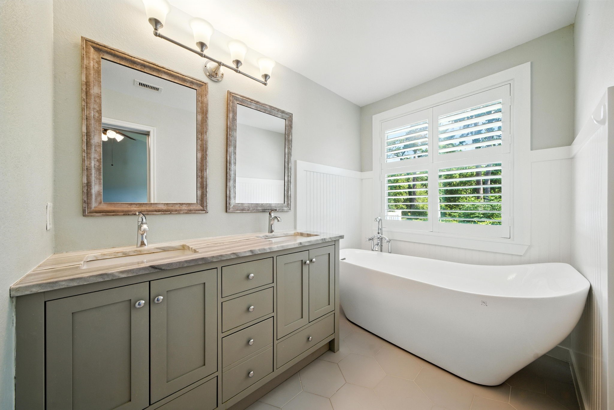 13600 Breton Ridge Street, Unit 7B Houston, TX 77070 - Photo 17 of 23 a spacious bathroom with a tub double sink window and mirror