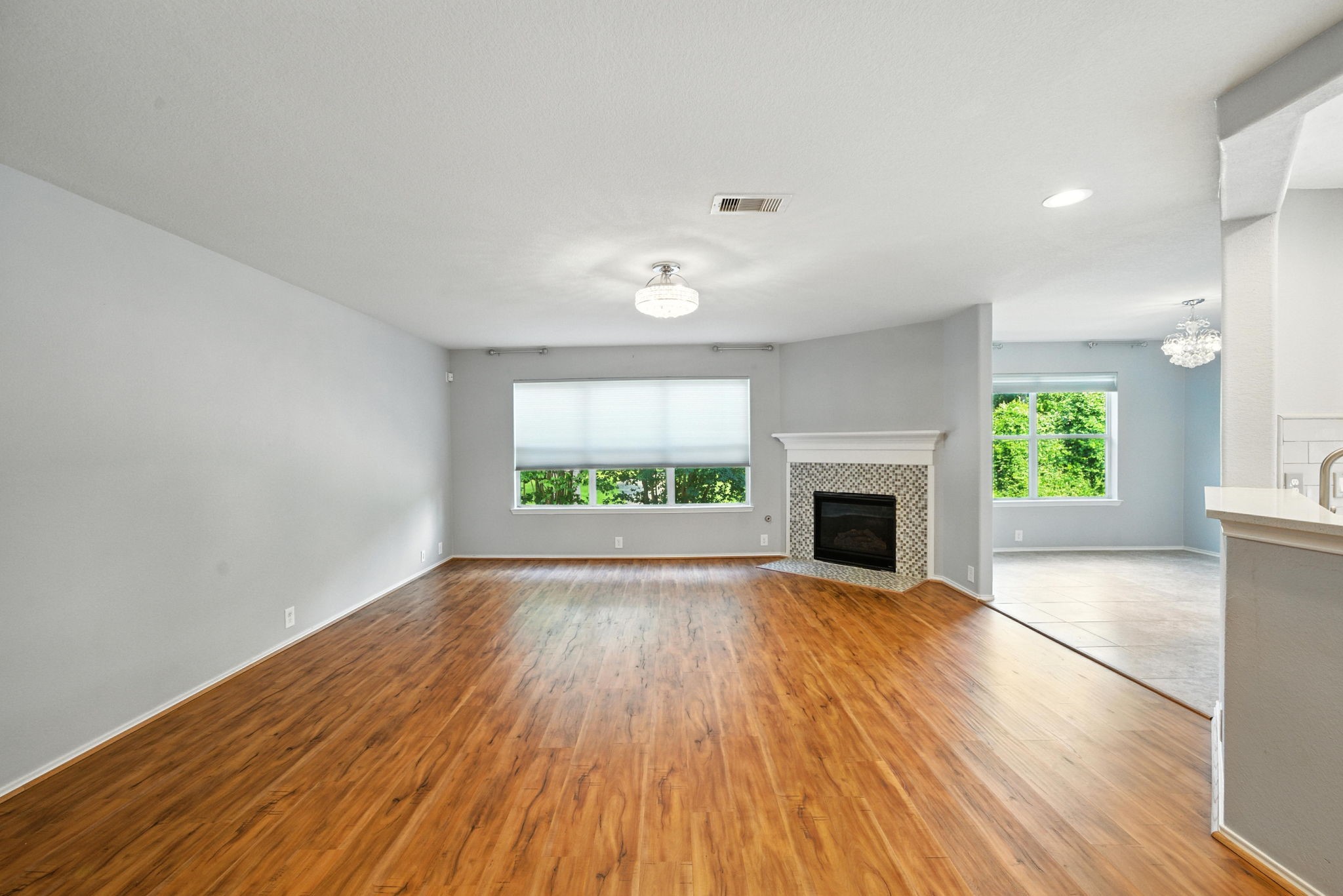 13600 Breton Ridge Street, Unit 7B Houston, TX 77070 - Photo 3 of 23 wooden floor fireplace and windows in an empty room