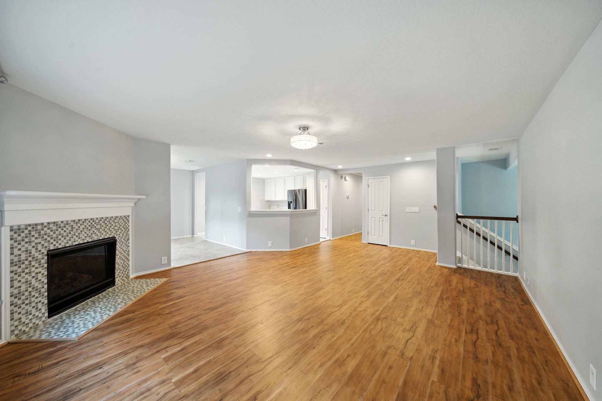 13600 Breton Ridge Street, Unit 7B Houston, TX 77070 - Photo 4 of 23 a view of empty room with wooden floor and fireplace