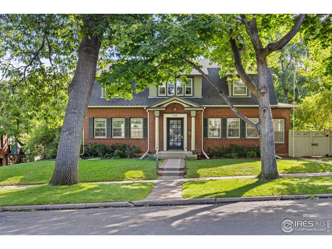 1064 10th Street Boulder, CO 80302 - Photo 1 of 40 a front view of a house with a yard