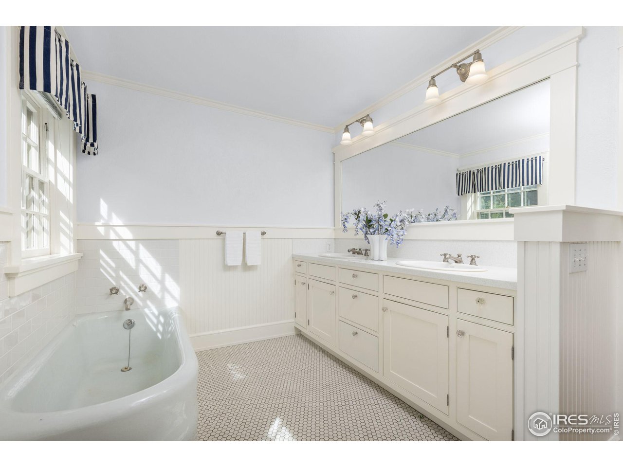 1064 10th Street Boulder, CO 80302 - Photo 17 of 40 a spacious bathroom with a sink a mirror and a bathtub