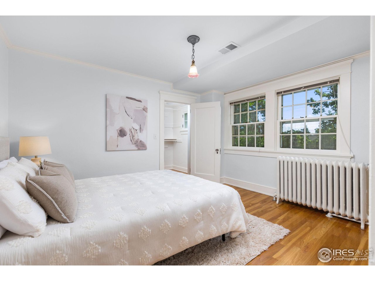 1064 10th Street Boulder, CO 80302 - Photo 19 of 40 a bedroom with a large bed and a window