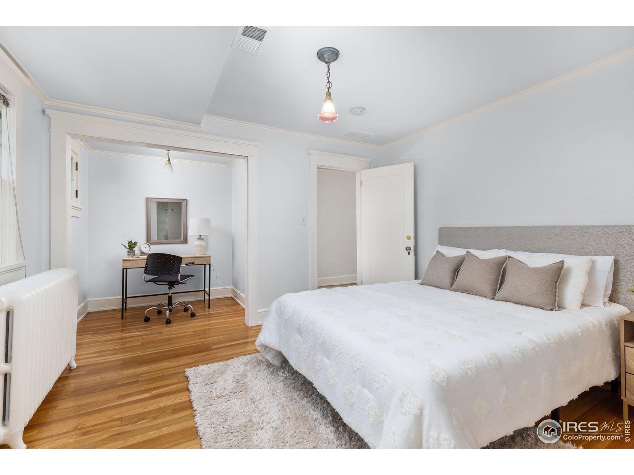 1064 10th Street Boulder, CO 80302 - Photo 20 of 40 a bedroom with a bed and wooden floor