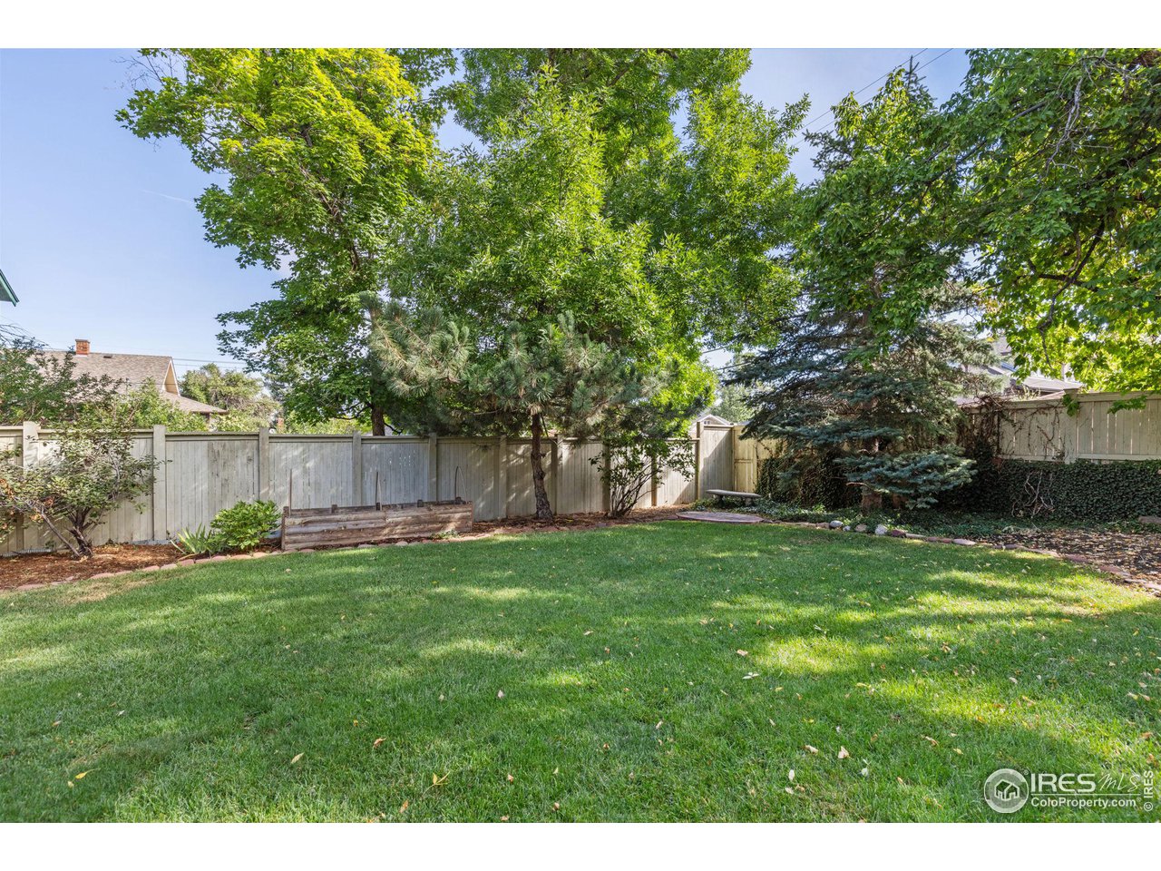 1064 10th Street Boulder, CO 80302 - Photo 30 of 40 a backyard of a house with lots of green space