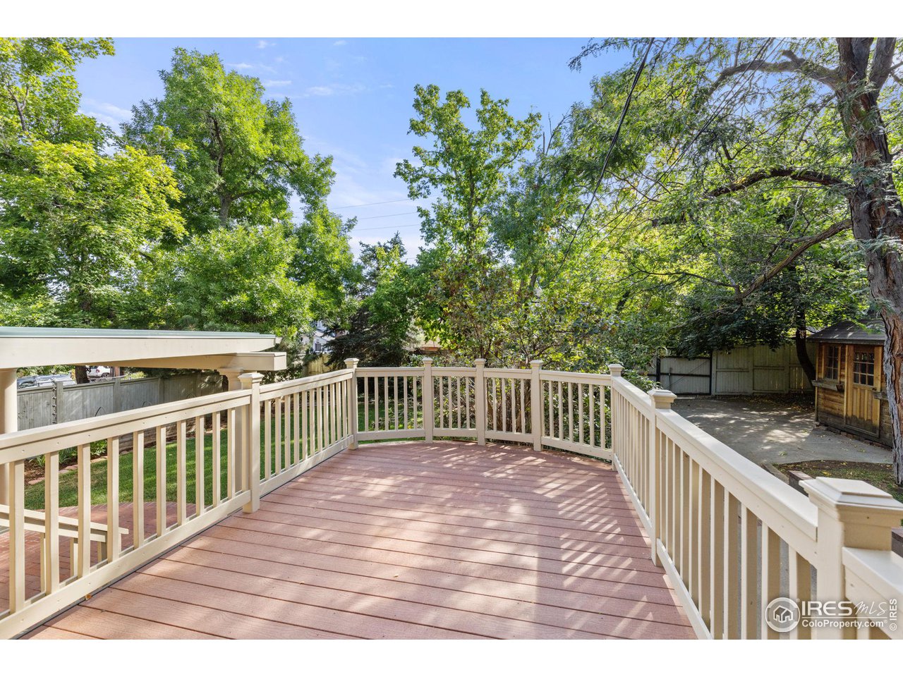 1064 10th Street Boulder, CO 80302 - Photo 31 of 40 a view of a wooden deck and a yard